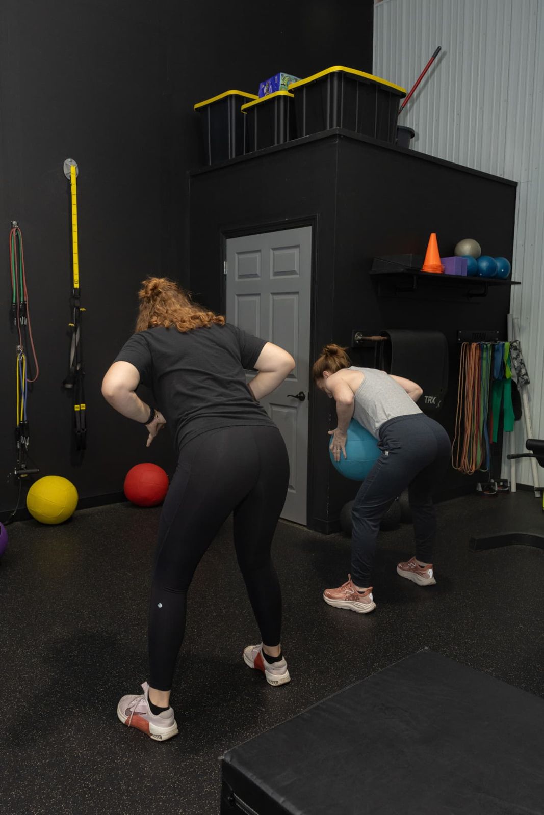 Trainer coaching a client through a hinge drill at RockeyFit