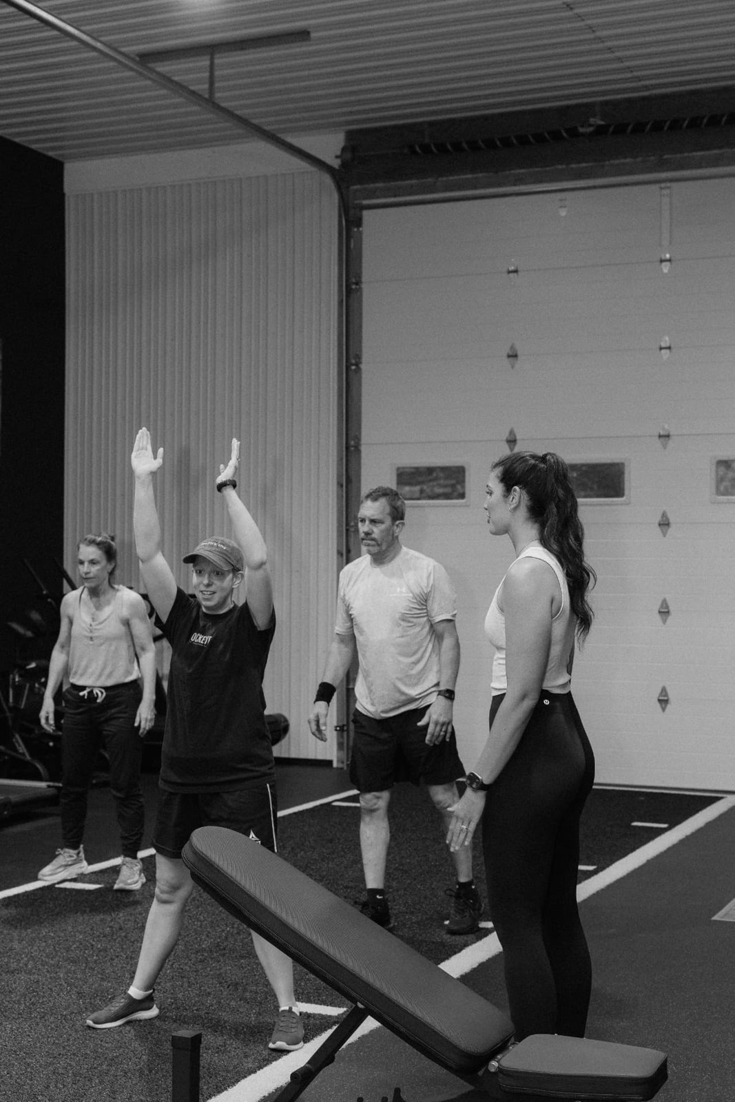 RockeyFit coach cueing an overhead movement during a small group session