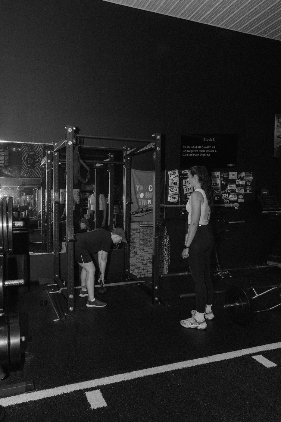 Trainer watching a client's kettlebell deadlift technique at RockeyFit