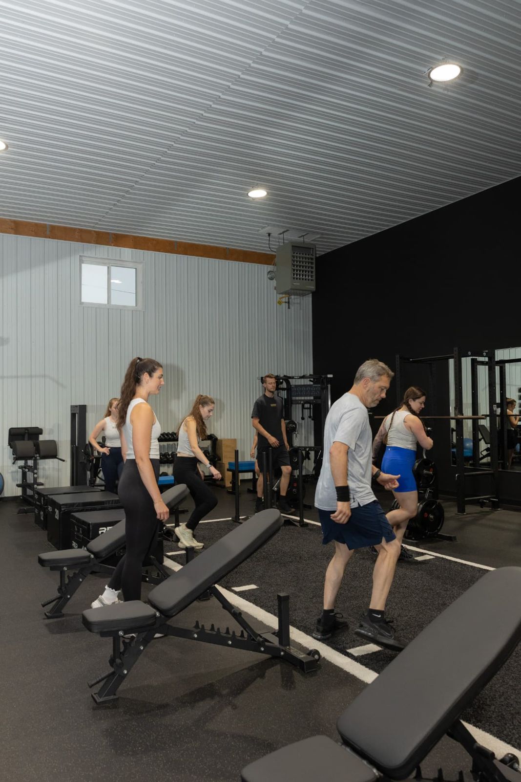 Members doing coached step-ups inside the RockeyFit studio
